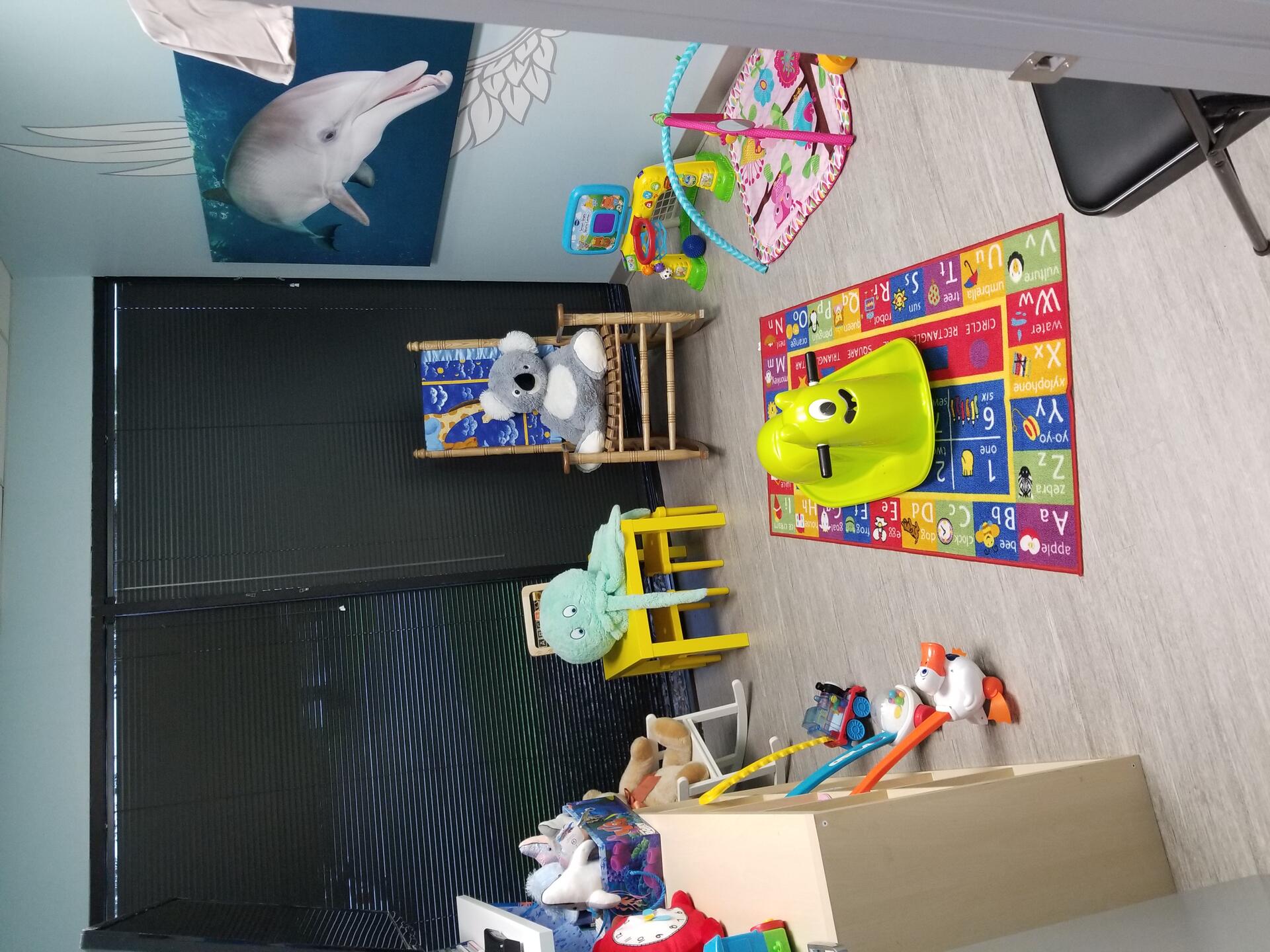 Hope Room — infant and toddler visitation space with toys and rocking chair at Angel Visitation Center